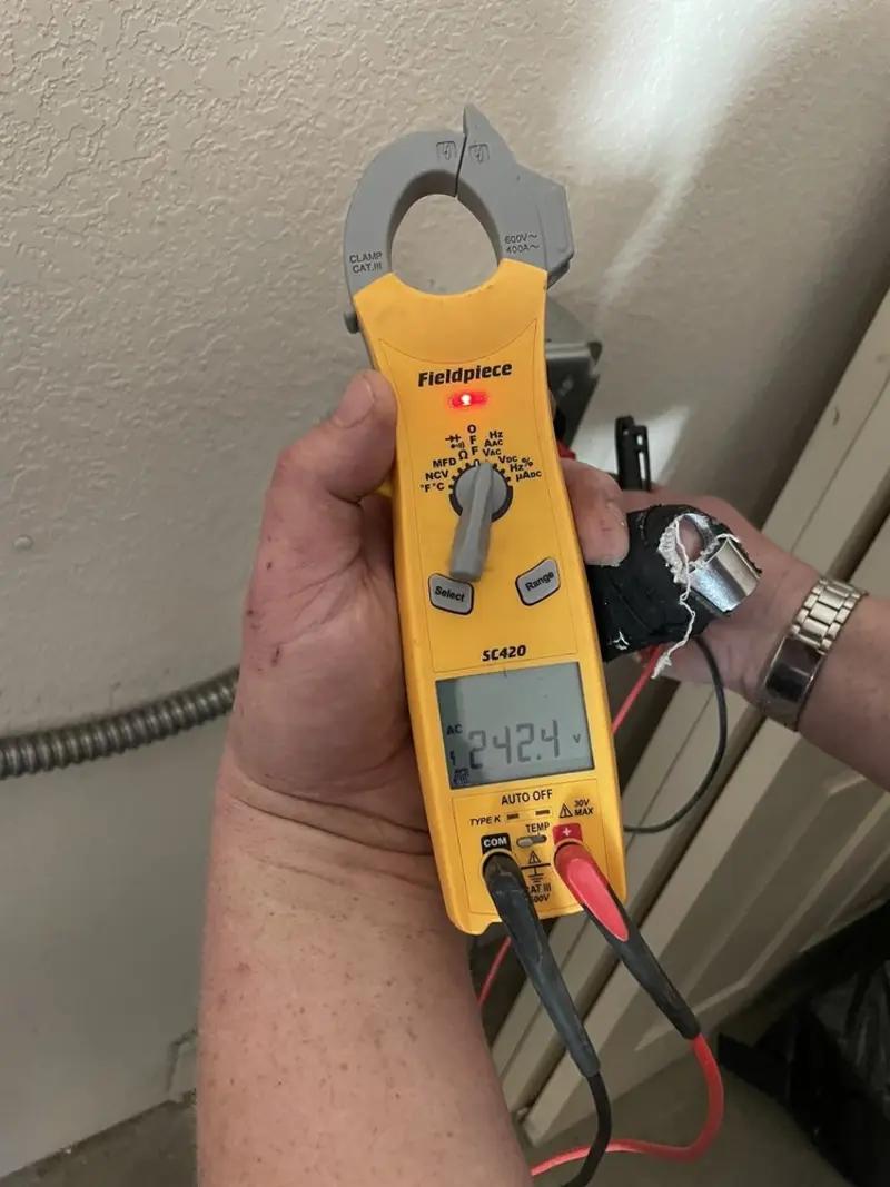 Voltage testing with clamp meter during Recessed Lighting Installation in Lawrence
